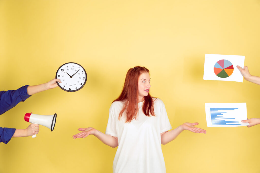 Caucasian young woman's portrait on yellow background, too much tasks